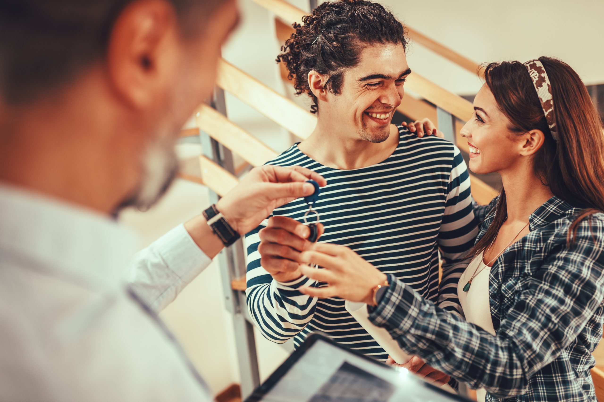 Man handing keys to a young couple and Predictions Millennials and Gen-Z
Maurcole Unlimited